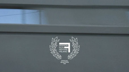White official selection laurel wreath logo of Fashion Film Festival Milano 2020 set against a grey background
