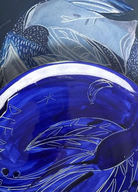 Abstract artwork of blue and white patterns featuring celestial motifs like stars and moons on a dark, textured background.