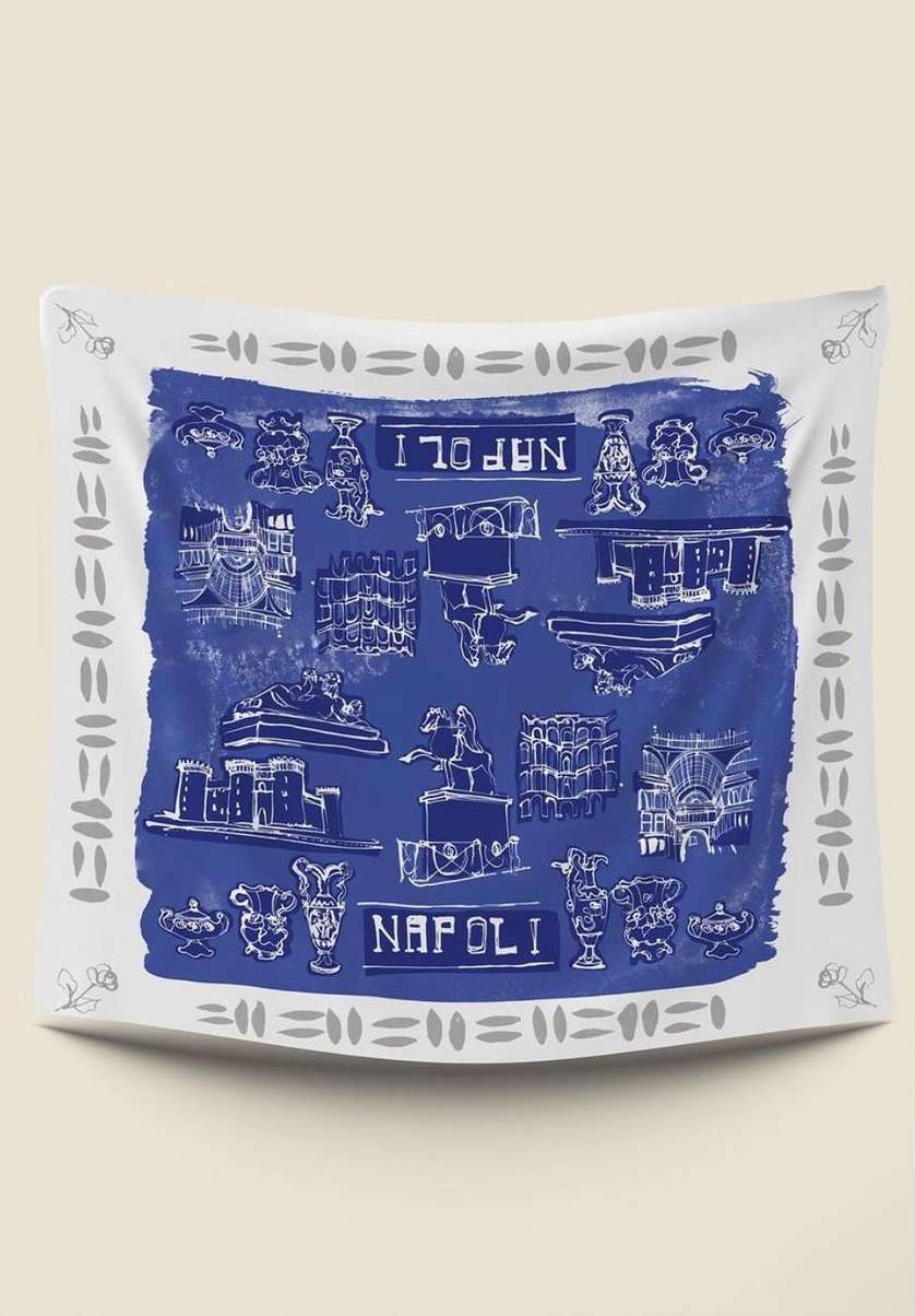 Square scarf featuring various drawings and the word Napoli in white ink on a blue background with a white and gray border.