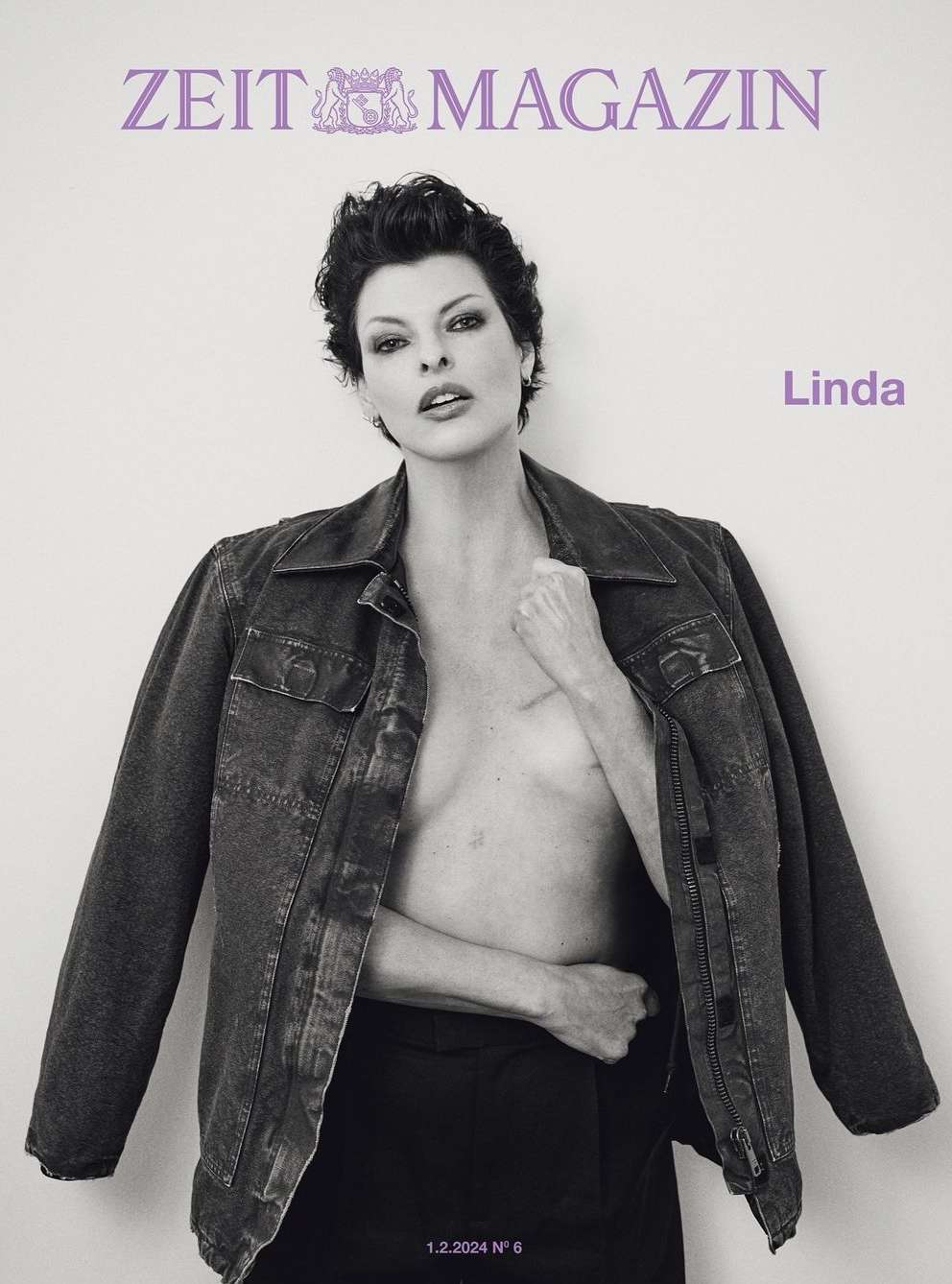 Monochrome magazine cover portrait of Linda Evangelista wearing a dark jacket and trousers against a light backdrop