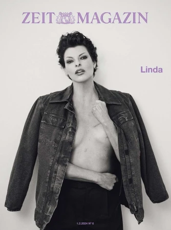 Monochrome magazine cover portrait of Linda Evangelista wearing a dark jacket and trousers against a light backdrop