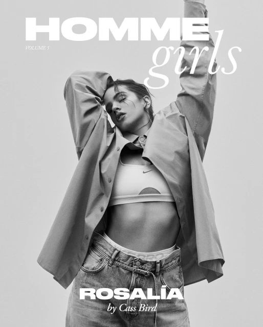 Black and white fashion magazine cover featuring a woman in a sports bra, jeans, and unbuttoned shirt striking a pose.