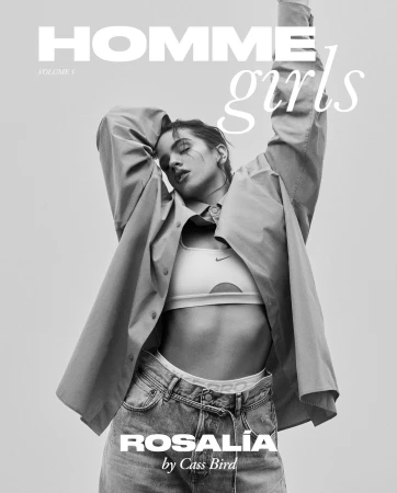 Black and white fashion magazine cover featuring a woman in a sports bra, jeans, and unbuttoned shirt striking a pose.