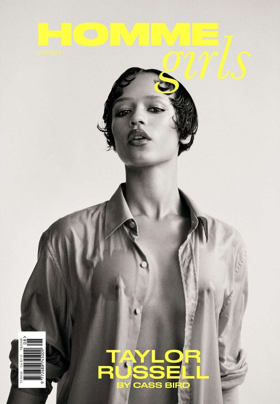 Black and white portrait of Taylor Russell on a magazine cover, featuring a wet hair look, wearing an open shirt against a light background.