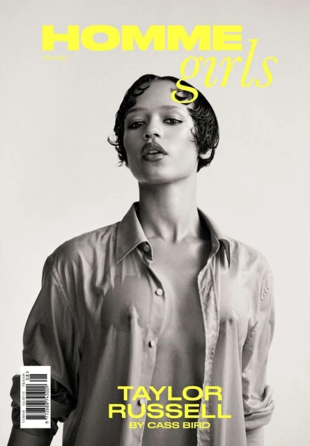 Black and white portrait of Taylor Russell on a magazine cover, featuring a wet hair look, wearing an open shirt against a light background.