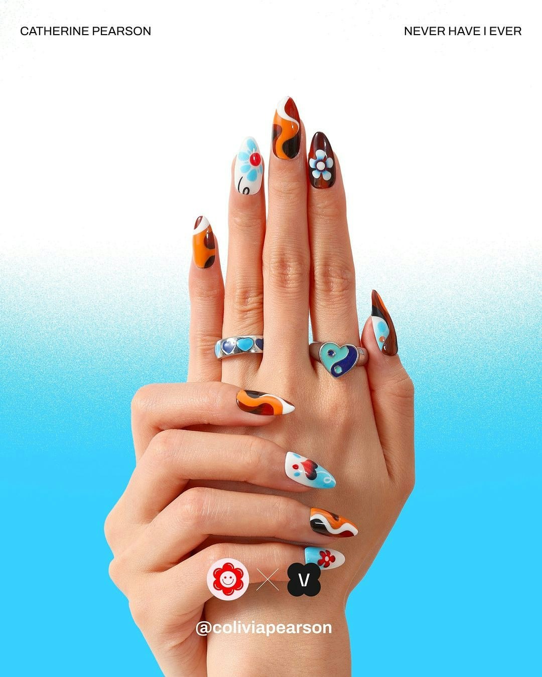 Close-up of a woman's hand showcasing a colourful manicure with nail art and a variety of rings against a gradient blue backdrop.