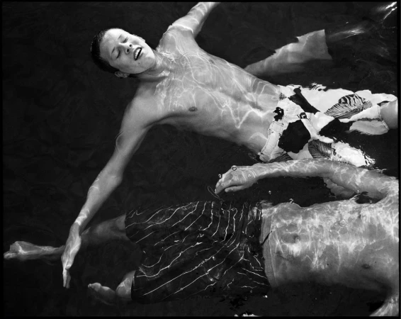 Black and white portrait of two young men floating underwater by photographer Cathrine Wessel
