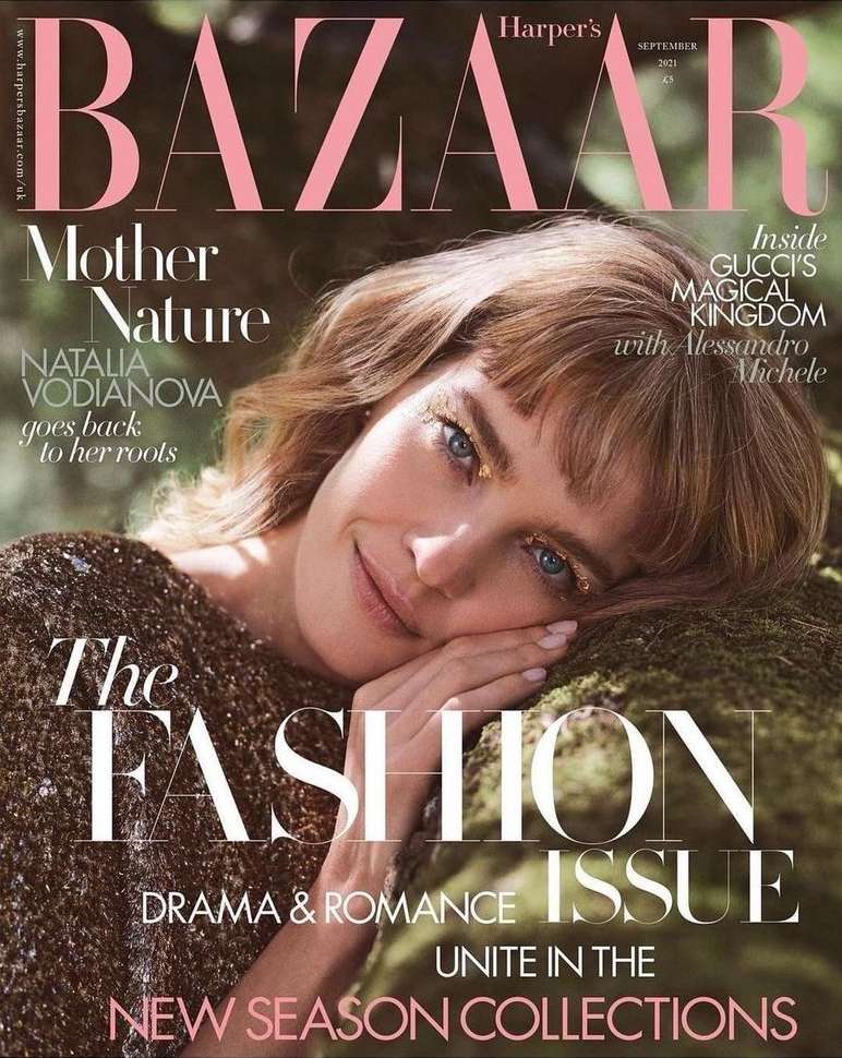 Bazaar cover featuring Natalia Vodianova. She is resting her head on moss with forest-like foliage in the background, shot in natural light.