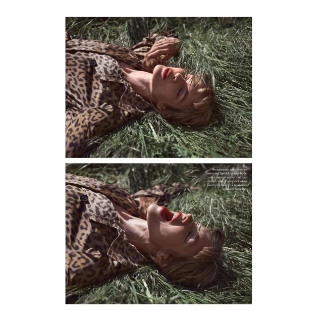 Woman in a leopard-print coat lies in tall green grass, eyes closed, mouth open, red lipstick, sunlit, outdoor fashion editorial.
