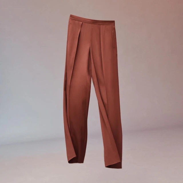 Pair of reddish-brown wide-leg trousers on a gradient background. Fashionable and stylish bottoms apparel for women.