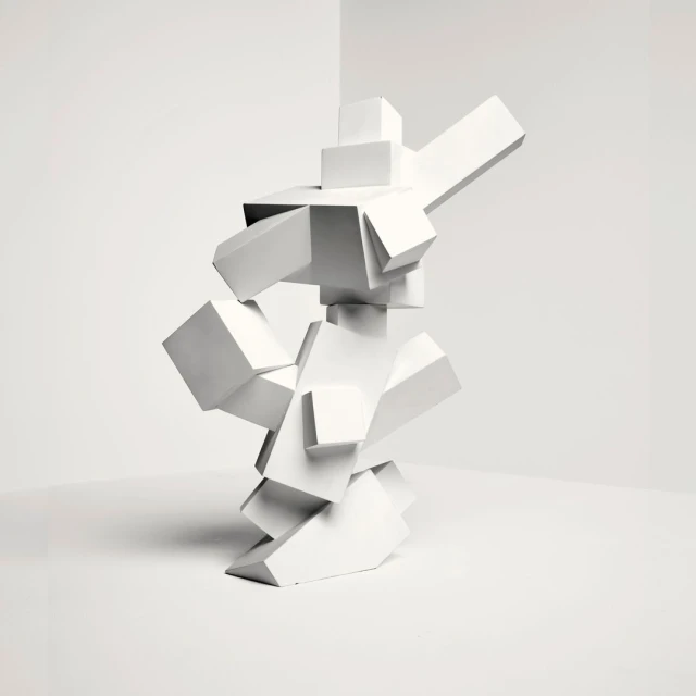 Abstract geometric sculpture of stacked white cubes in a bright, minimalist corner with bright, even lighting for a modern art display.