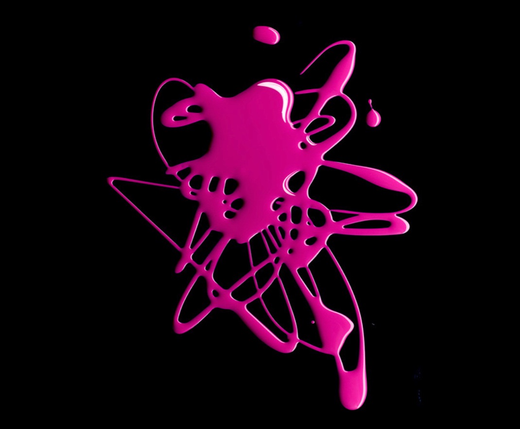 Abstract splash of vibrant pink nail polish on a solid black background creates a high-contrast, modern visual effect with glossy texture.