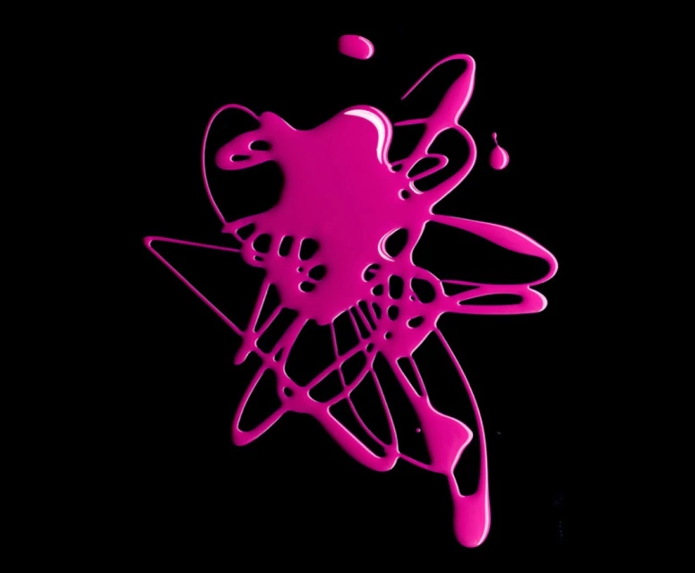 Abstract splash of vibrant pink nail polish on a solid black background creates a high-contrast, modern visual effect with glossy texture.