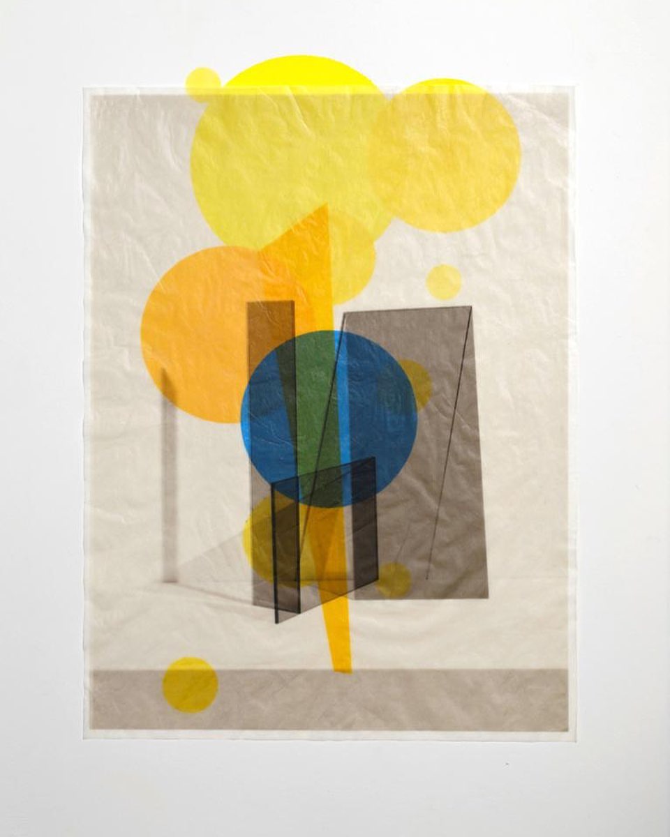 Abstract artwork featuring translucent overlapping shapes of yellow, orange, blue, green, and black on a white backdrop, studio lighting.