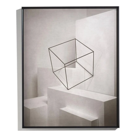 Geometric art print with a black wireframe cube floating above white geometric shapes, all framed in black on a white background.