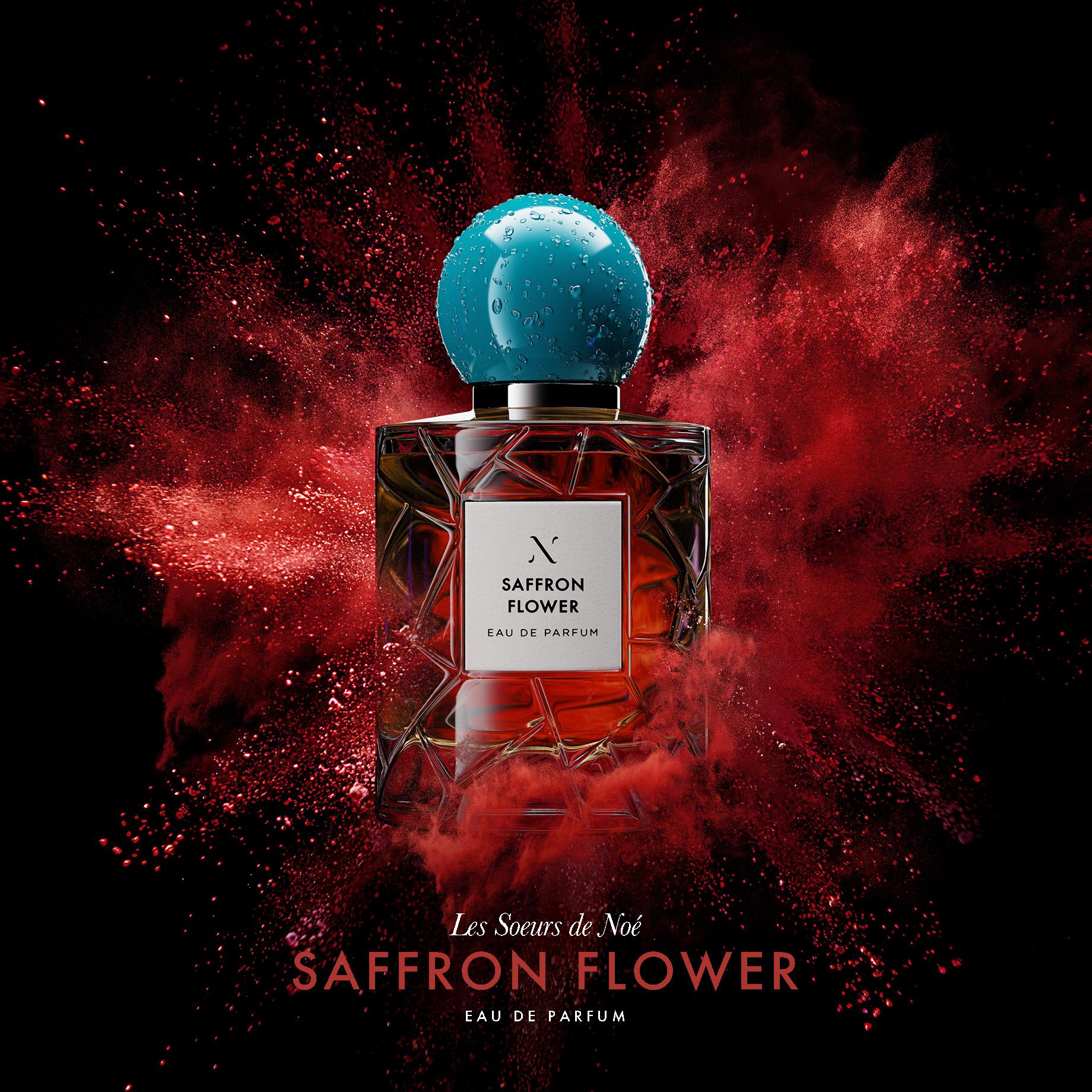 Elegant perfume bottle with blue cap on black background surrounded by red powder explosion, promoting beauty and fragrance products.