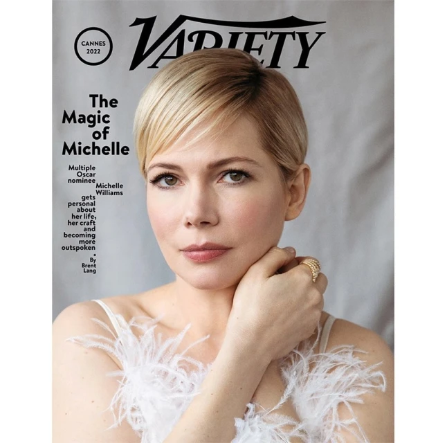 Michelle Williams on Variety cover. Close-up of woman with blonde hair wearing white dress with feather details, against a light gray backdrop.