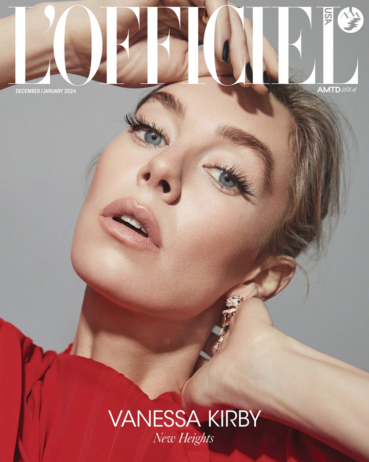 Vanessa Kirby poses in a close-up fashion magazine cover shoot, wearing a red dress and statement earrings against a grey backdrop.