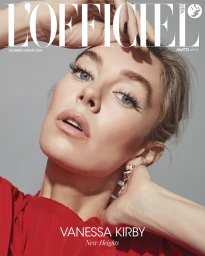 Close-up portrait of actress Vanessa Kirby with blonde hair in a red top against a grey backdrop for L'Officiel magazine.