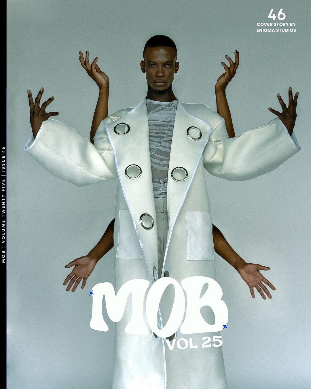Magazine cover features a Black male model in an oversized white coat, arms raised, with a surreal, multi-limbed effect against a grey backdrop.