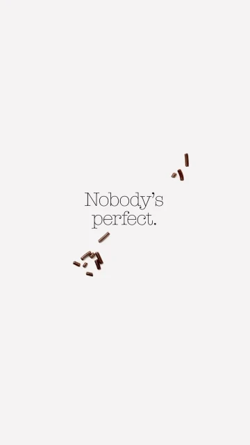 Scattered chocolate sprinkles on a white background with the text 'Nobody's perfect.' creates a minimalist, food-themed visual.
