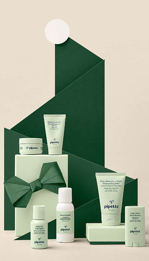 Assortment of Pipette baby skincare products in green and white packaging, arranged in a visually appealing presentation, beauty product