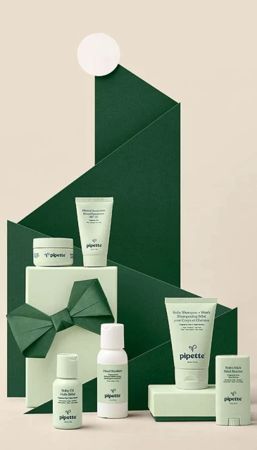 Assortment of Pipette baby skincare products in green and white packaging, arranged in a visually appealing presentation, beauty product
