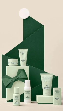 Assortment of Pipette baby skincare products in green and white packaging, arranged in a visually appealing presentation, beauty product