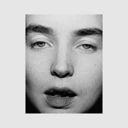 Extreme close-up monochrome portrait of a person face with detailed skin texture and dark eyebrows