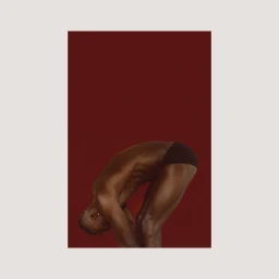Black man bending over wearing dark underwear against a solid dark red studio background by Chadwick Tyler