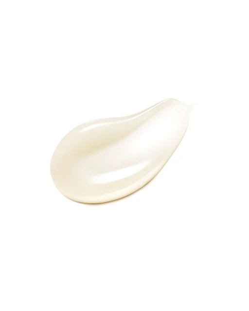 Close-up of a light beige cream smear with a glossy texture on a white background, showing product consistency.