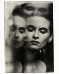 Black and white portrait of a woman with multiple exposures creating ghostly layered facial expressions.