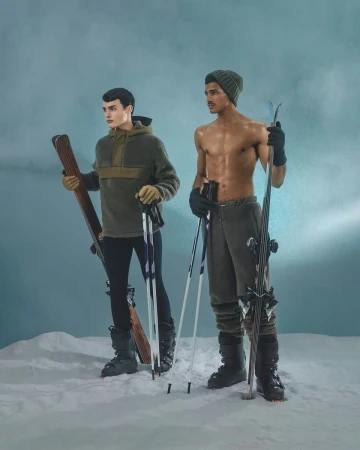 Two athletic men pose in winter ski outfits against a blue backdrop, holding skis and poles, embodying a blend of fitness and fashion.
