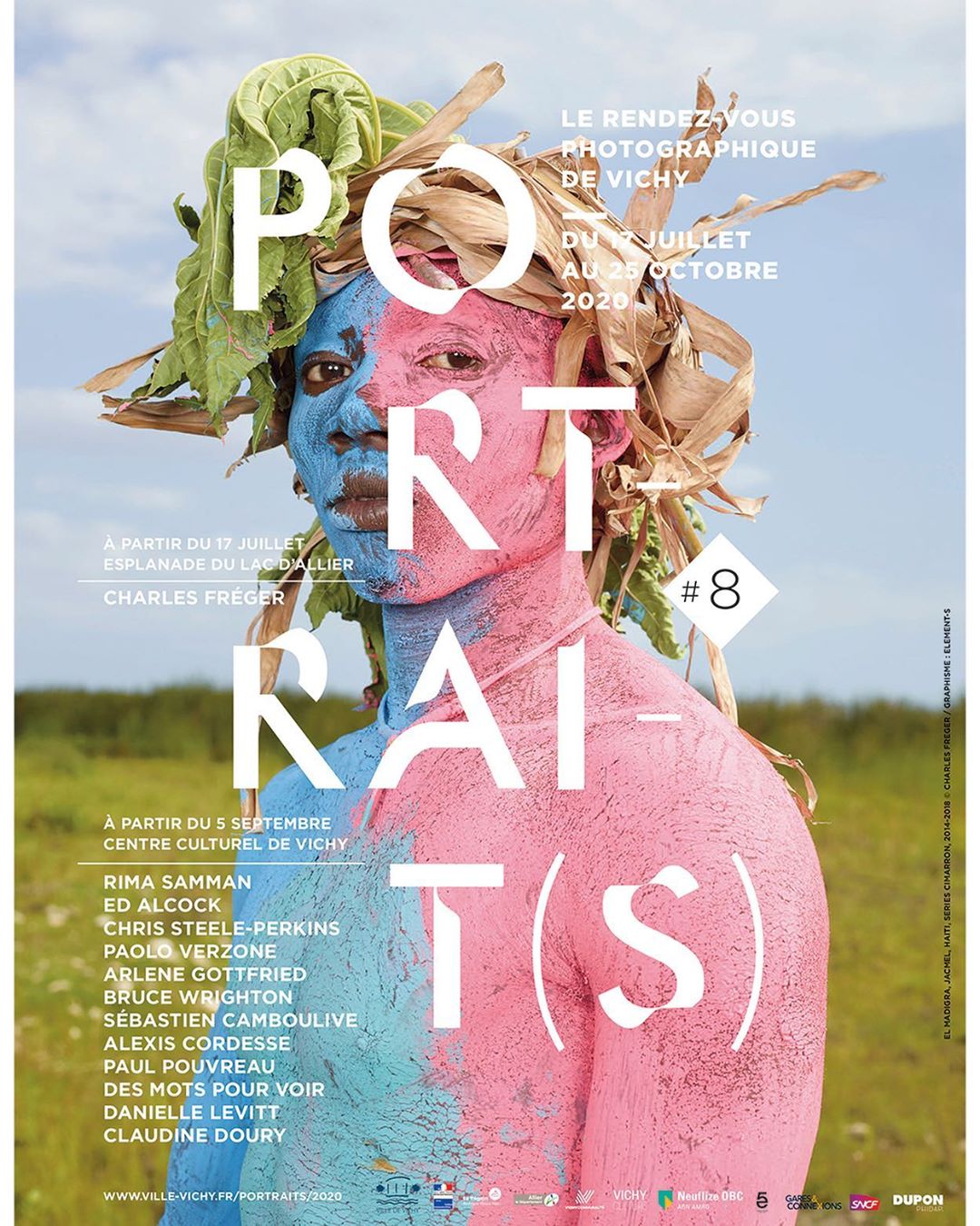 Unique portrait with half blue and half pink face, adorned with natural elements against a bright sky, presented as an art exhibition poster.