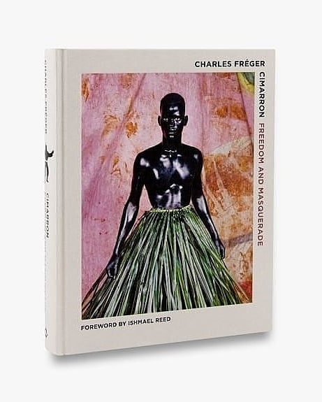 Book cover featuring a photograph of a dark-skinned person wearing a skirt made of green foliage against a textured pink backdrop.