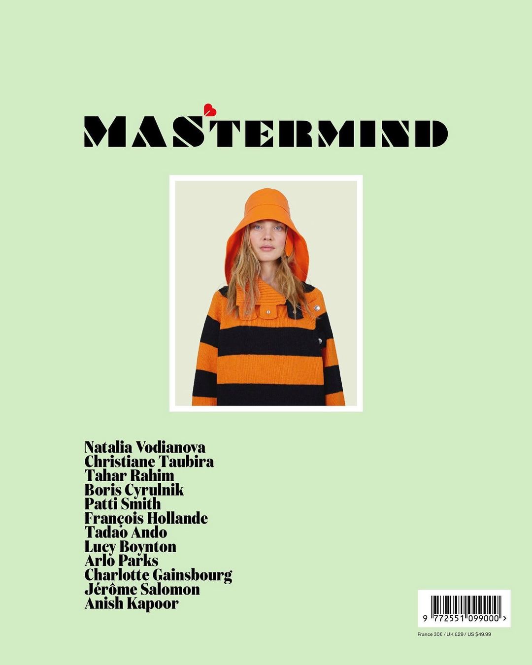 Magazine cover featuring a woman in a striped orange and black shirt and orange bucket hat, set against a light green background.