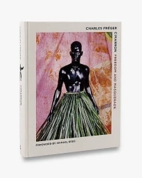 Hardcover photography book titled Cimarron Freedom and Masquerade by Charles Freger against a plain white background