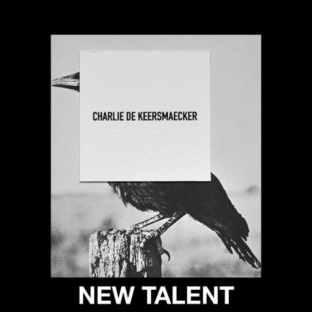Monochrome image of a black crow perched on a wooden post with a white card overlaid, featuring the text 'Charlie De Keersmaecker'.