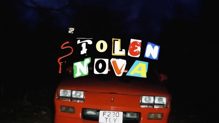 An overhead shot of a red coupe with the phrase 'Stolen Nova' floating above the hood in front of a dark night sky background.