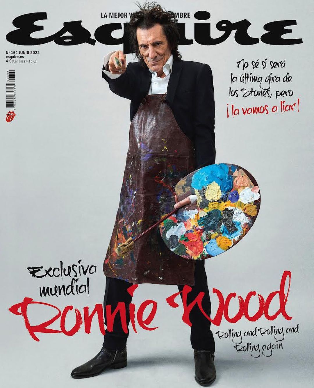 Esquire magazine cover featuring Ronnie Wood in a suit and apron, holding a paint palette and pointing at the viewer in a studio setting.