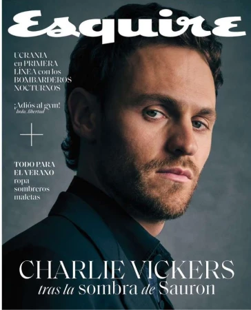 Portrait of actor Charlie Vickers wearing a dark shirt against a textured grey background for Esquire magazine