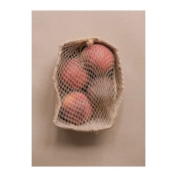 Fresh peaches inside a woven mesh produce bag resting on a neutral textured brown paper background.