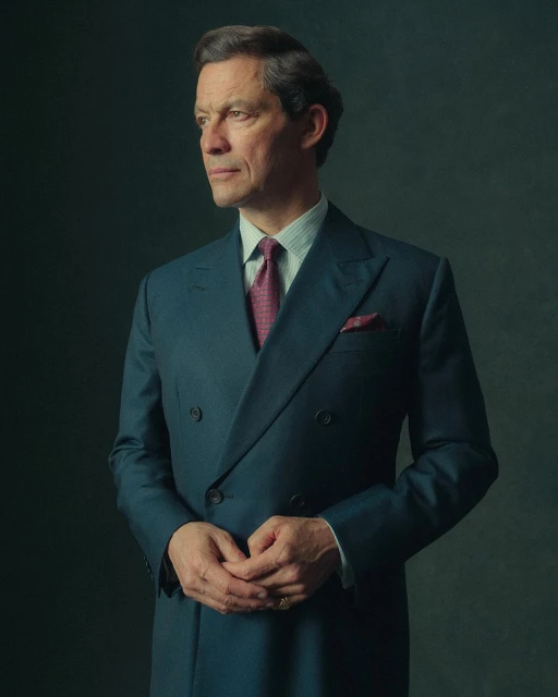Portrait of a mature man in a teal suit looking off to the side, set against a dark background in a formal setting.