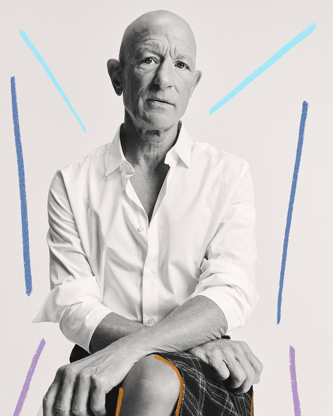 Bald man seated in a white button-down shirt and patterned skirt, captured in a medium shot with pastel graphic accents on a white background.