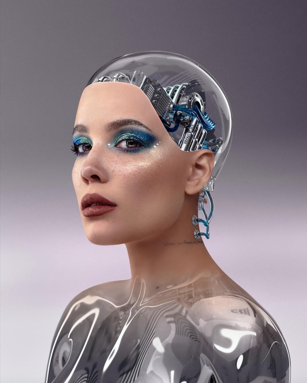 Glamorous portrait of a woman with a robotic headpiece, wearing makeup and ornate earrings, against a soft, neutral studio backdrop.