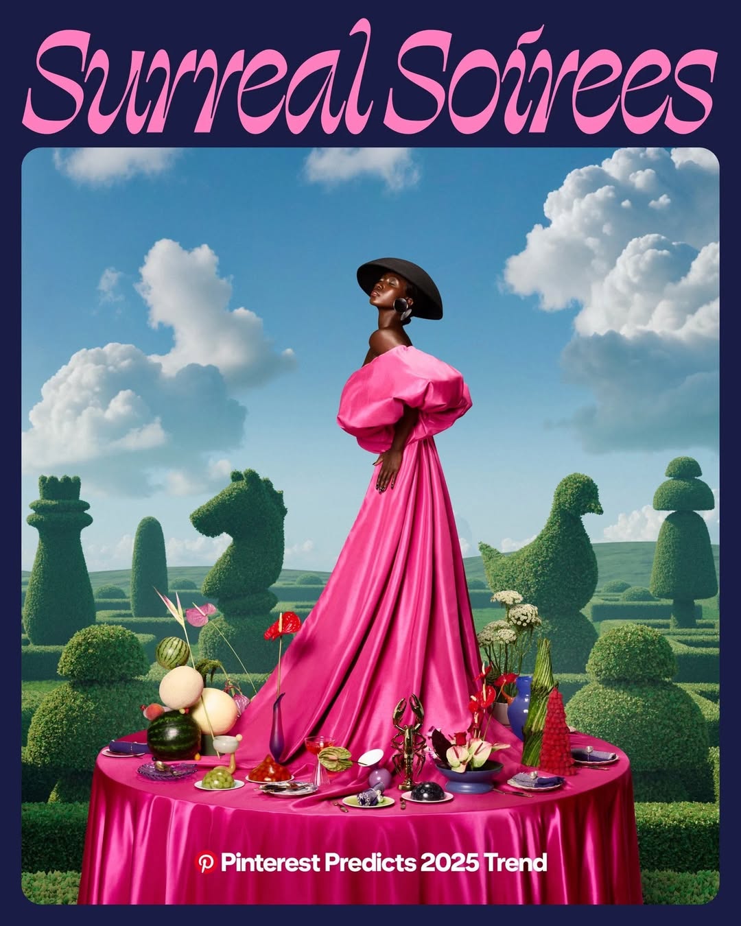 Black woman in a pink gown stands at a table with assorted dishes and drinks, in an outdoor garden with topiary art and blue skies.