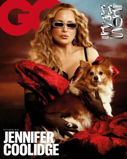 Jennifer Coolidge on a magazine cover with a dog. She wears black sunglasses and a red gown. The cover says GQ and 2023 Heroes.