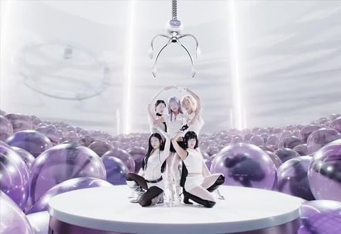 A group of five young women pose on a white platform, surrounded by lavender spheres, with a robotic claw suspended above them.