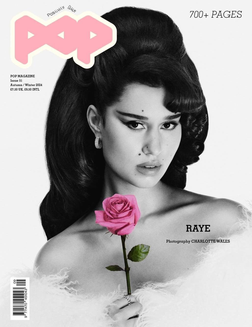 Monochrome magazine cover featuring singer Raye with voluminous retro hair holding a vibrant pink rose.