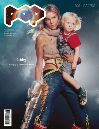 Magazine cover featuring an adult and a child, with sci-fi-inspired styling, including an adult holding a toy laser gun.